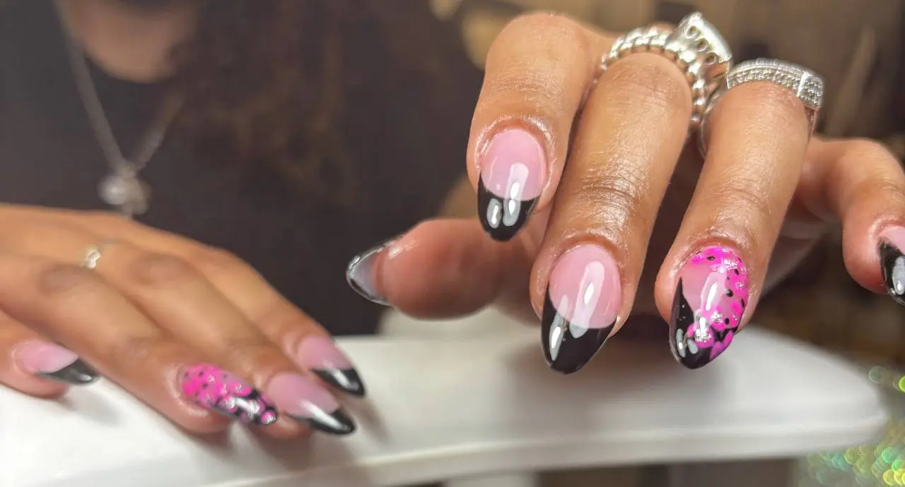 Black French tips with hot pink glitter art at NailLou Salon