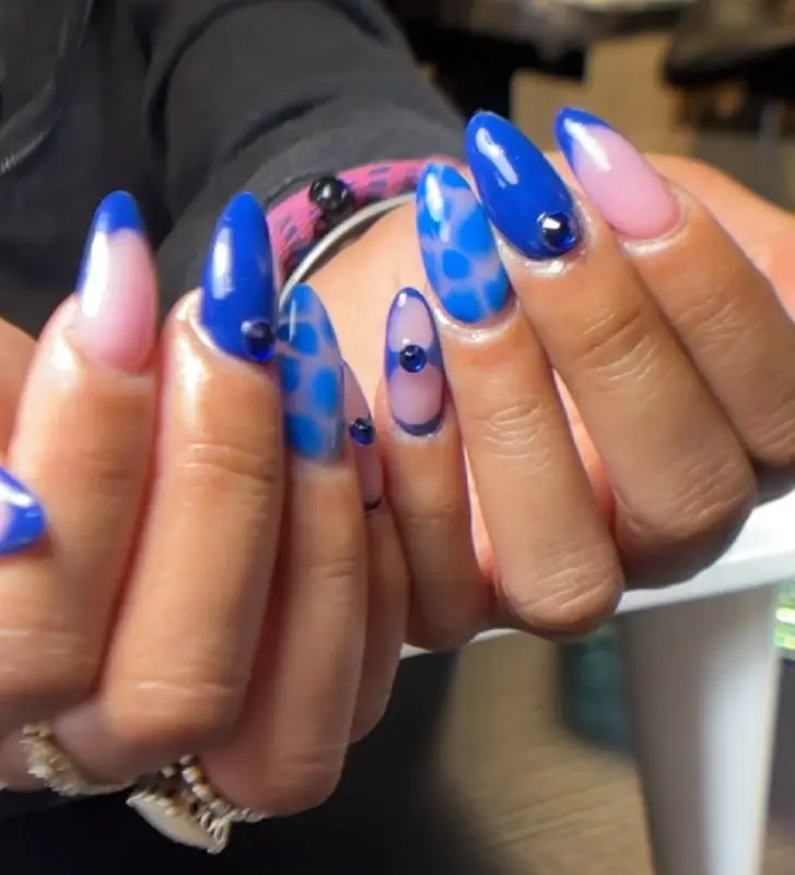 Blue animal-print nail art with gems at NailLou Salon