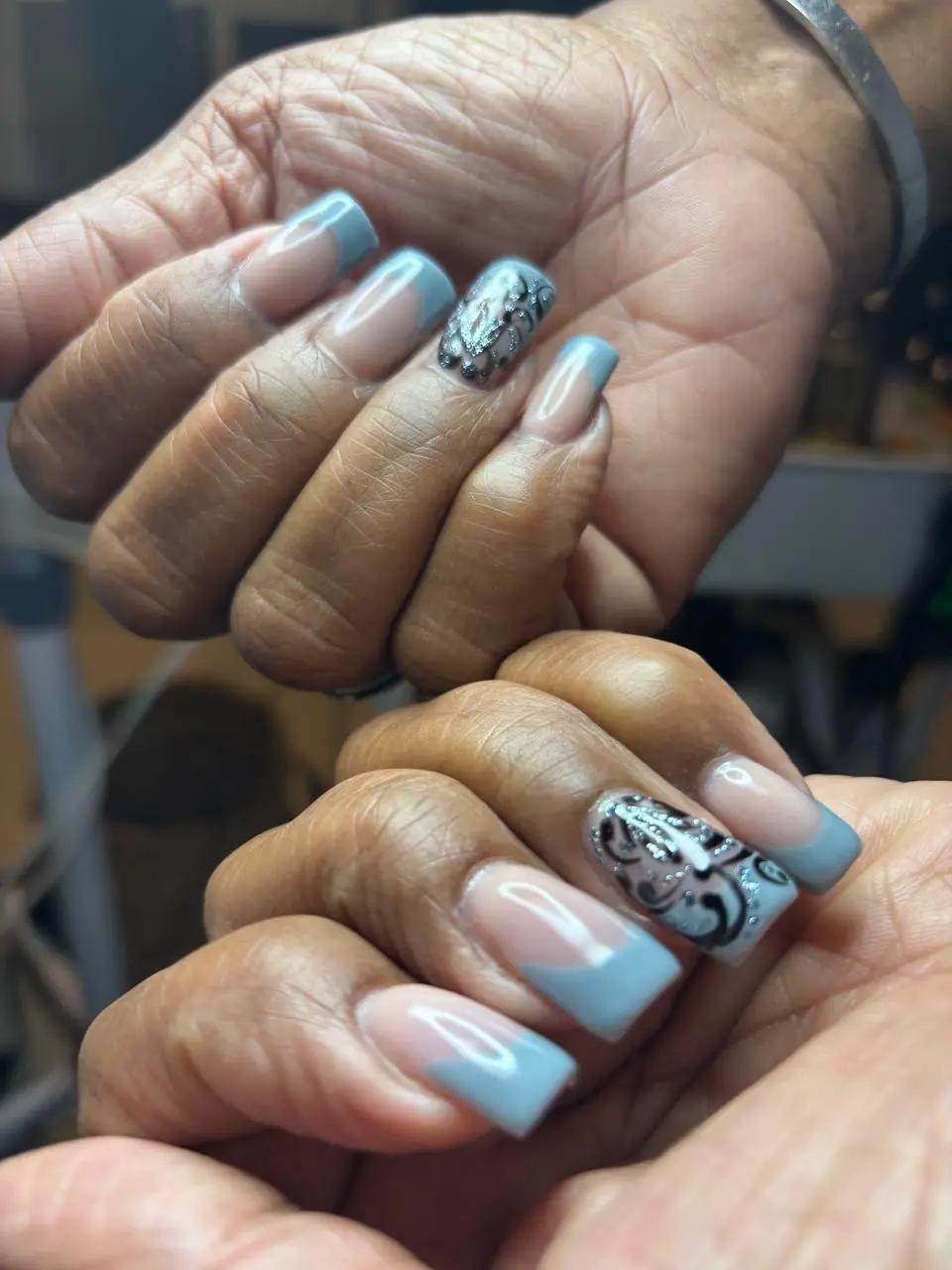 Blue-grey French tips with silver filigree nail art at NailLou Salon