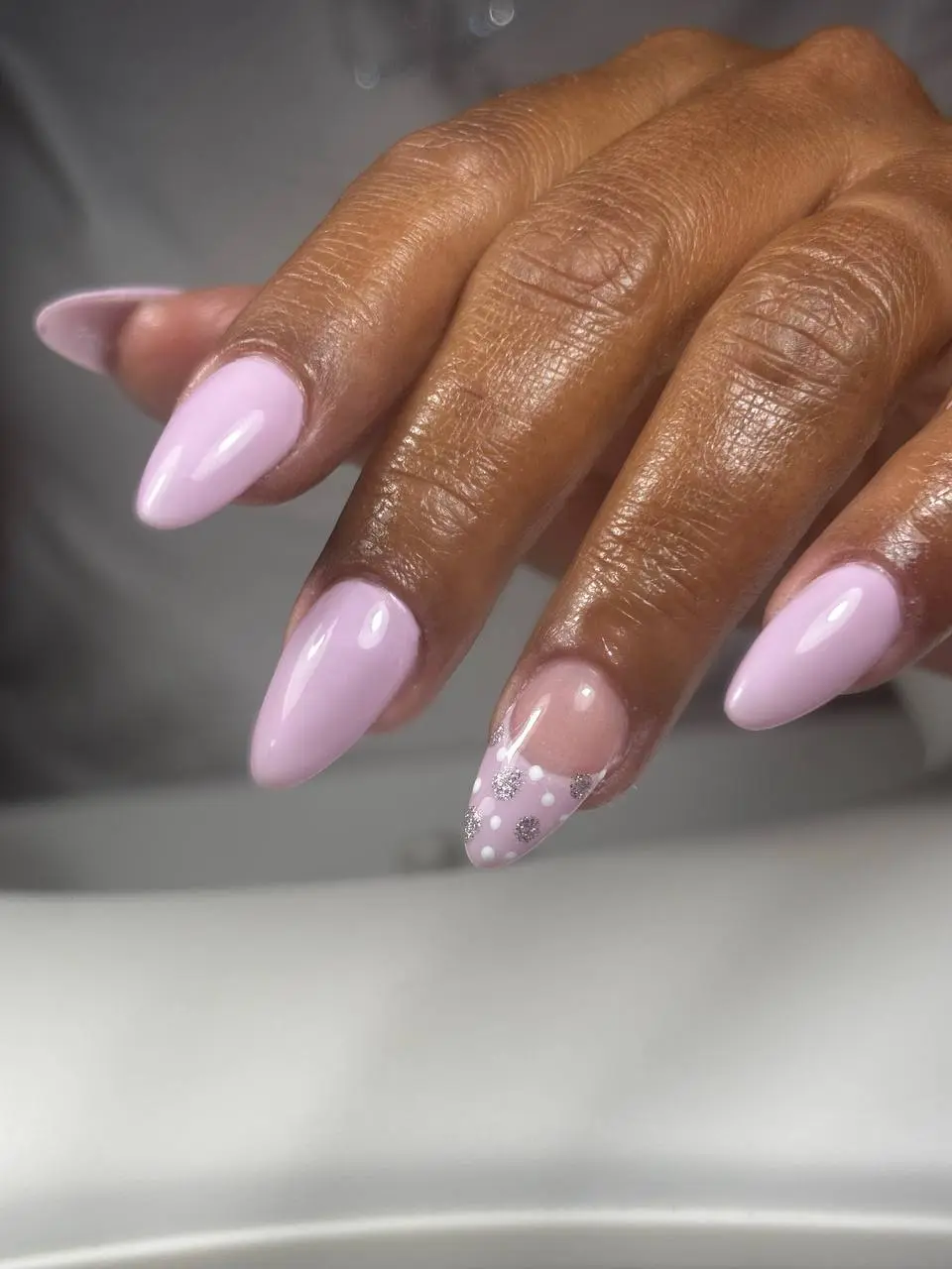 Lilac almond manicure with glitter accent at NailLou Salon