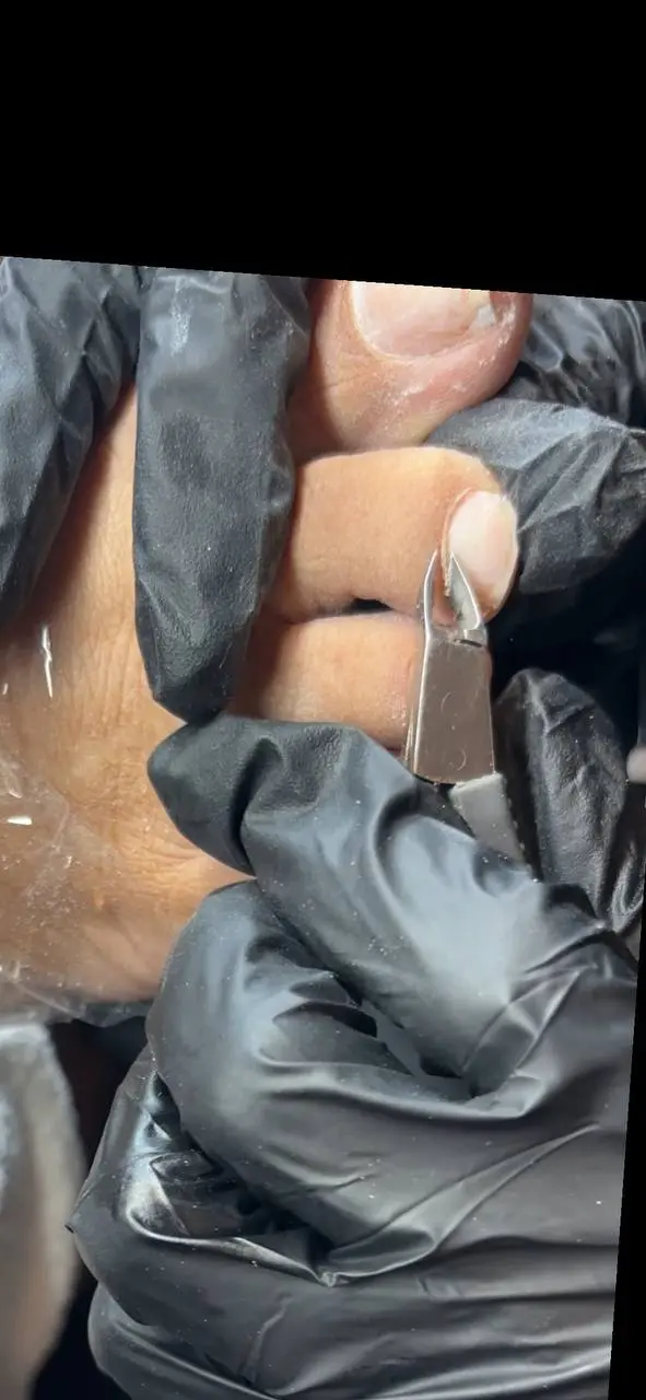 Precision nail care technique at NailLou Salon